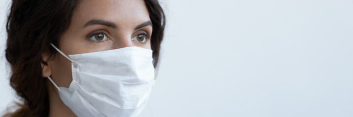 Head shot close up young woman wearing mouth nose individual air pollution or anti virus protective facial mask, banner with copy free space for advertising text, public healthcare awareness concept.