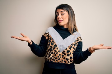 Sticker - Young beautiful woman wearing casual sweatshirt standing over isolated white background clueless and confused with open arms, no idea concept.