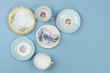 Top View Of Pretty Vintage China Teacups On Pale Blue Background