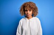 © Krakenimages.com - Beautiful african american sporty woman wearing casual sweatshirt over blue background skeptic and nervous, frowning upset because of problem. Negative person.