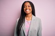 © Krakenimages.com - Young african american business woman standing over pink isolated background with a happy and cool smile on face. Lucky person.