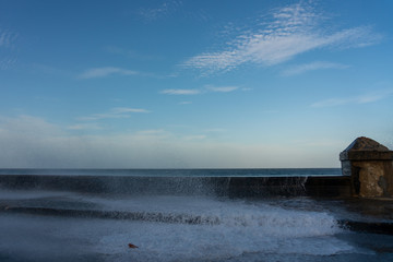 Wall Mural - Sea water in the street as a result of waves crashing into the Maleco wall. Havana. Cuba.