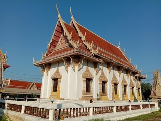 Church of Buddhist temple isolated on blue sky background closeup. Is a place religious ceremonies for Thailand people culture.