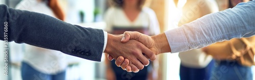 Cuadros en Lienzo Group of business workers standing together shaking hands at the office