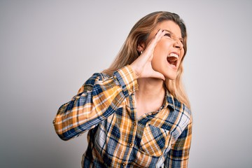 Sticker - Young beautiful blonde woman wearing casual shirt standing over isolated white background shouting and screaming loud to side with hand on mouth. Communication concept.