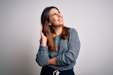 Canvas Print - Young beautiful brunette woman smiling happy and confident. Standing with smile on face wearing casual sweater over isolated white background