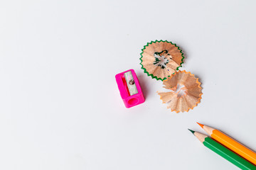 Color pencils with sharpener on white background.