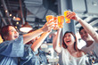© Tom Wang - happy young group dining and drinking beer at restaurant