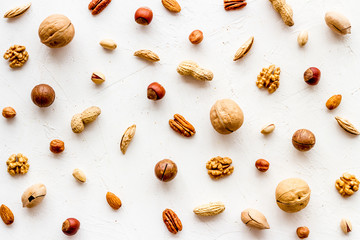 Wall Mural - Nuts background - with almond, macadamia, walnut - on white table top-down