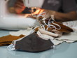 Work at home woman sitting sewing a fabric mask, for dust and germs pm 2.5, virus covid 19