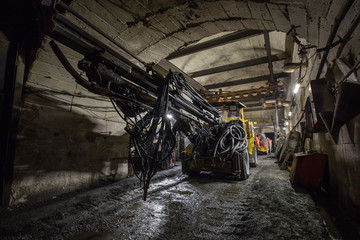 Wall Mural - Underground gold mine tunnel with drilling machine