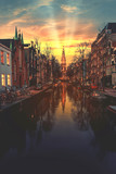 Fototapeta Big Ben - Warm sunset on the canal of Amsterdam reflected on the calm water, Netherlands