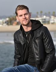 Happy young man by the ocean