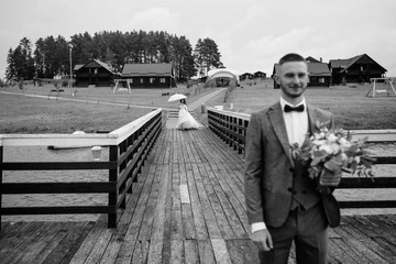 Wall Mural - the bride and groom are in an embrace on the pier