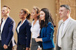 © DragonImages - Group of positive ambitious business people walking in the street