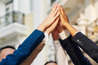 © DragonImages - Group of successful business people giving high five together
