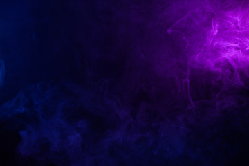Wall Mural - soft clouds of colorful smoke on dark background