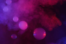 Soap Bubbles Filled With Smoke Flowing Over Abstract Colorful Clouds Of Vapor