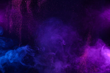 Smoke colorful clouds and shiny glitter bursts. Abstract outer space fairy tale background.