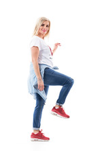 Happy Middle Age Casual Woman Climbing Up On Stairs Or Ladder Turning And Smiling At Camera. Full Body Length Isolated On White Background.