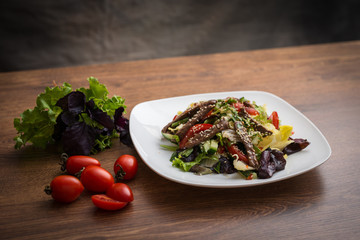 Fresh salad with grilled beef , arugula and tomato. Top view