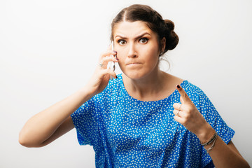 Wall Mural - beautiful woman emotionally talking on a mobile phone