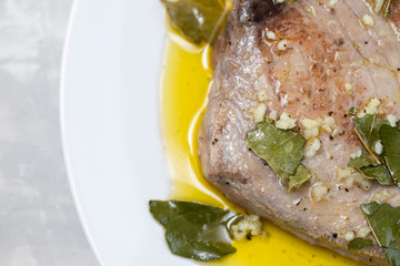 Poster - fried tuna with garlic, bay leaf and olive oil on white plate