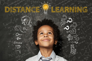 Distance learning. Black child boy with idea light bulb, question marks and science formulas