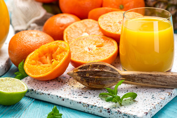 Wall Mural - Making Fresh Orange Juice with Wooden Squeezer. Healthy and Clean Eating