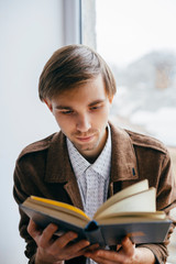 Wall Mural - Young man reading a book