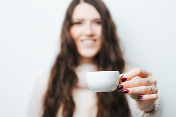 girl holding a cup of coffee