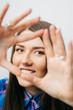 © aeroking - Playful beautiful young blond woman making a heart gesture with her fingers to show her love and affection or that she likes something