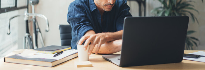 Man working on laptop at bright studio