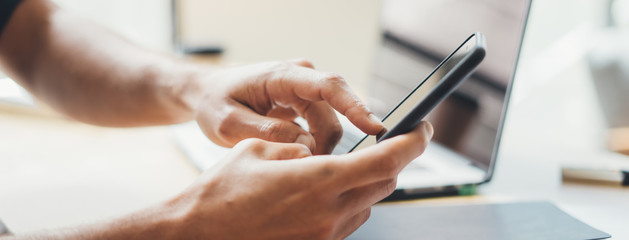 Close-up photo of male hands with smartphone