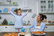 © Тарас Нагирняк - Young beautiful mother and her little daughter playing in the kitchen during breakfast at home.