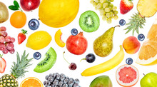Creative Photo Of Many Different Exotic Tropical Bright Fruits Isolated On A White Background. View From Above. Bright Summer Fruit Pattern.