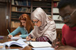 © Rido - Muslim young woman studying with classmates