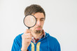 © aeroking - on a gray background young man with a magnifying glass