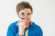© aeroking - on a gray background young man with a magnifying glass