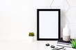 © Ester_K - Office desk at home. Black frame mockup.