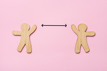 Keep Distance Concept, Two Wooden People On Pink Background, Preventive Measures, Infection Control