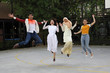 © oqba - Group young asian chinese malay man woman wearing headscarf outdoor jump in the air happy exited