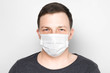 Man with medical mask on face. Protection against viruses and infections. Stay home, corona virus.
