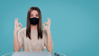 © South House Studio - A middle shot of female in medical mask showing ok sign, isolated, copy space