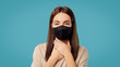 © South House Studio - Brunette sick female in mask holds her hands on her throat