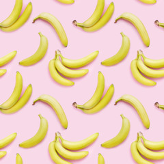 Wall Mural - Bananas on a pink background, top view. Seamless pattern, food background.