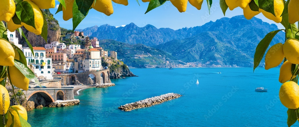 Small town Atrani on Amalfi Coast in province of Salerno, Campania region, Italy. Amalfi coast is popular travel and holyday destination in Italy. Ripe yellow lemons in foreground. - obrazy, fototapety, plakaty 