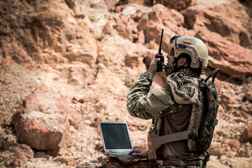 Soldiers of special forces on wars at the desert,Thailand people,Army soldier use laptop for see map with satellite,Using Radio For Communication During Military Operation