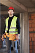 © Nikola Spasenoski - construction site worker wearing velt with tools