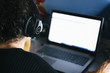 © Raul Mellado - woman listening music with headphones on laptop